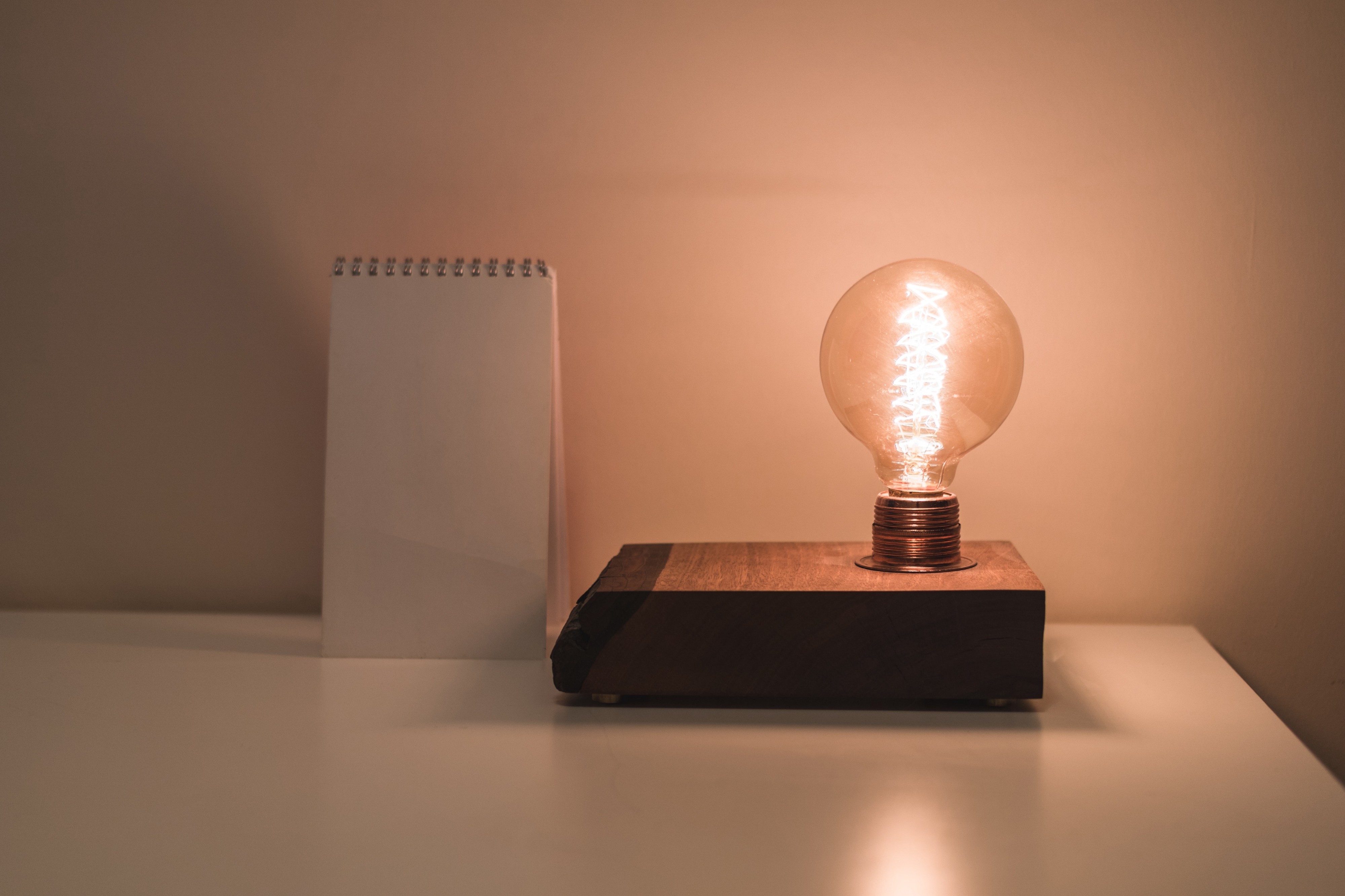 A warm Light bulb and a notepad